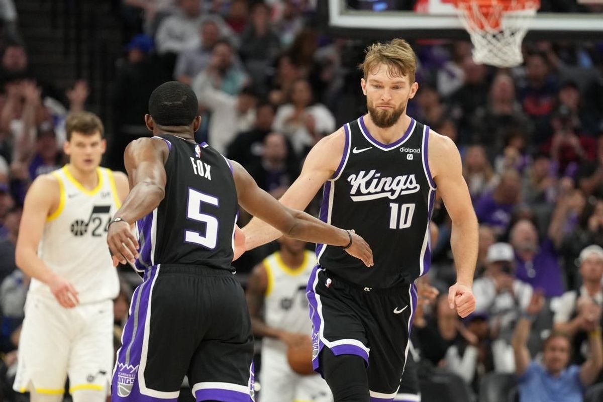 Mar 31, 2024; Sacramento, California, USA; Sacramento Kings guard De'Aaron Fox (5) is congratulated by forward Domantas Sabonis (10) after scoring during the third quarter against the Utah Jazz at Golden 1 Center.