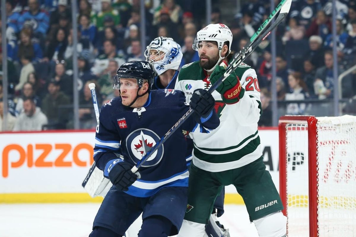 Dec 30, 2023; Winnipeg, Manitoba, CAN;  Winnipeg Jets defenseman Nate Schmidt (88) jostles for position with Minnesota Wild forward Patrick Maroon (20) in front of goaltender Connor Hellebuyck (37) during the first period at Canada Life Centre.