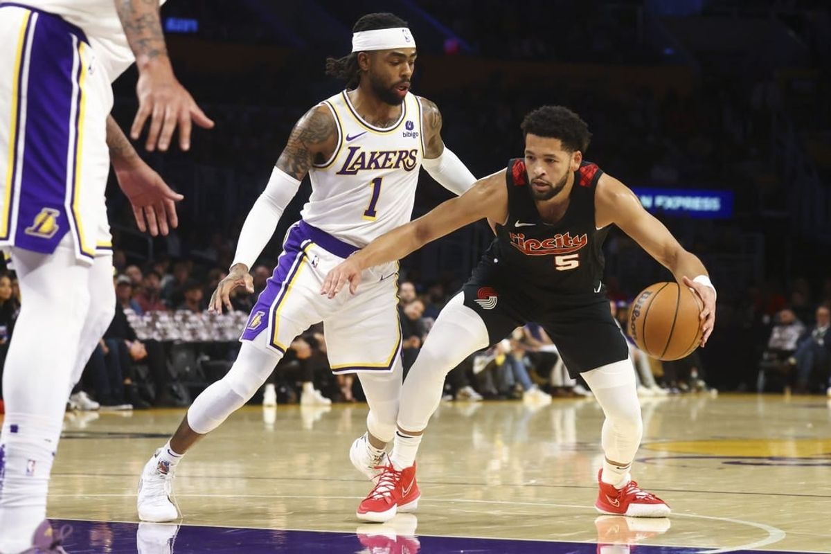 Nov 12, 2023; Los Angeles, California, USA; Portland Trail Blazers guard Skylar Mays (5) drives against the Los Angeles Lakers guard D'Angelo Russell (1) during the first half of a game at Crypto.com Arena.