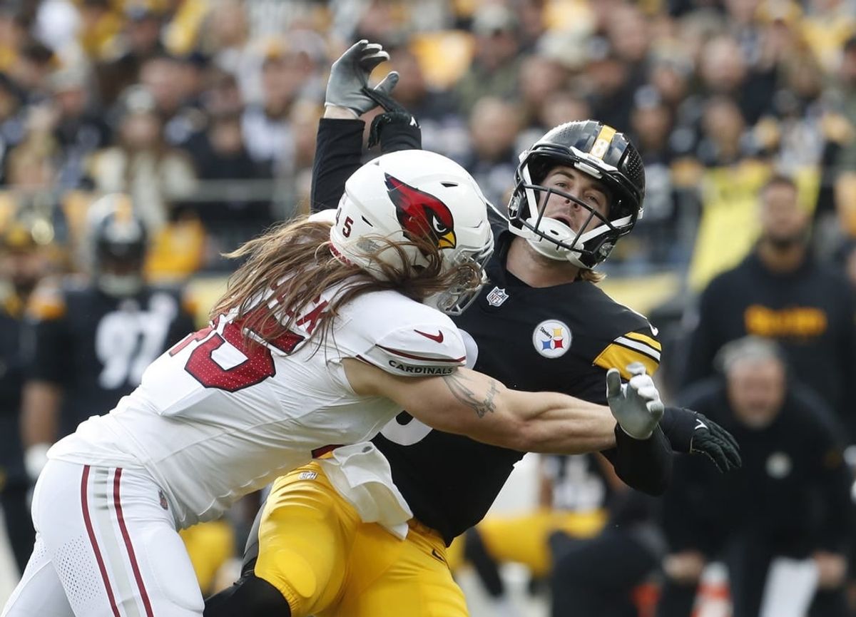 Dec 3, 2023; Pittsburgh, Pennsylvania, USA; Arizona Cardinals linebacker Dennis Gardeck (45) hits Pittsburgh Steelers quarterback Kenny Pickett (8) as he releases the football during the first quarter at Acrisure Stadium.