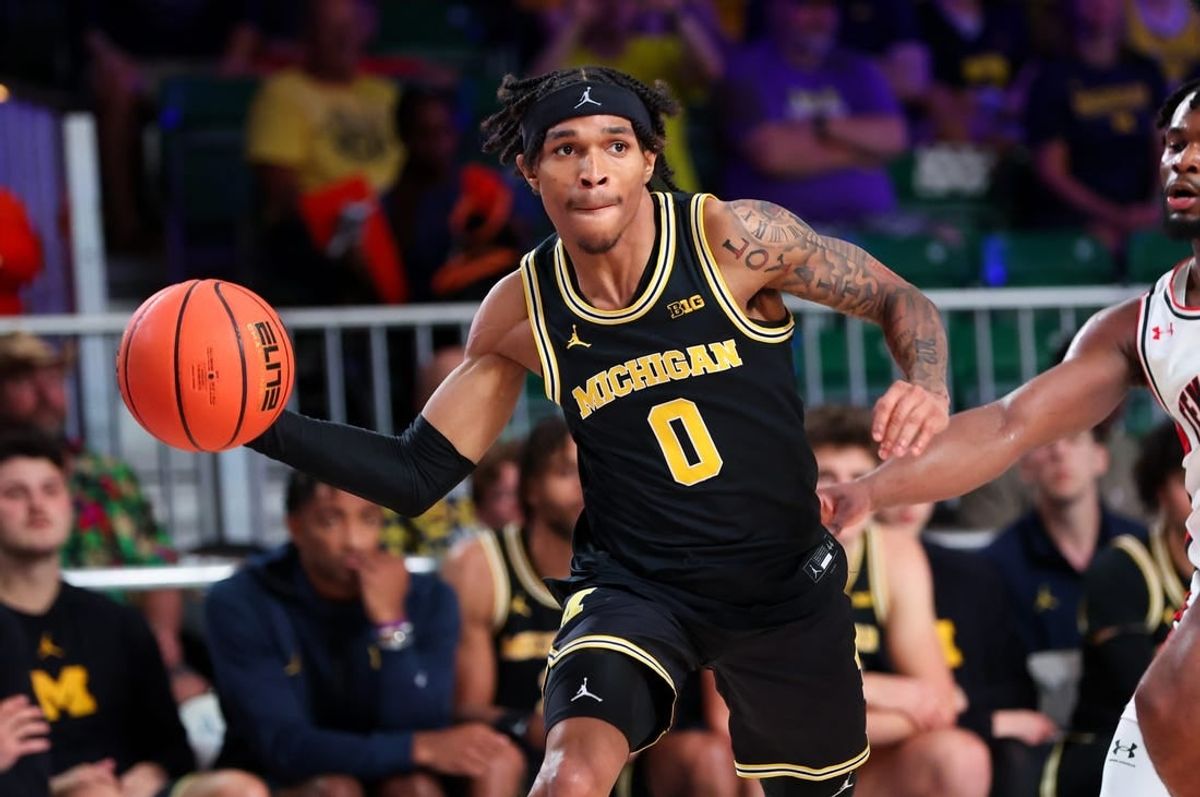 Nov 24, 2023; Paradise Island, BAHAMAS;  Michigan Wolverines guard Dug McDaniel (0) passes the ball during the second half against the Texas Tech Red Raiders at Imperial Arena.
