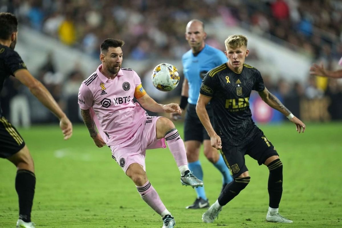 Sep 3, 2023; Los Angeles, California, USA; Inter Miami CF forward Lionel Messi (10) and LAFC midfielder Mateusz Bogusz (19) battle for the ball at BMO Stadium.