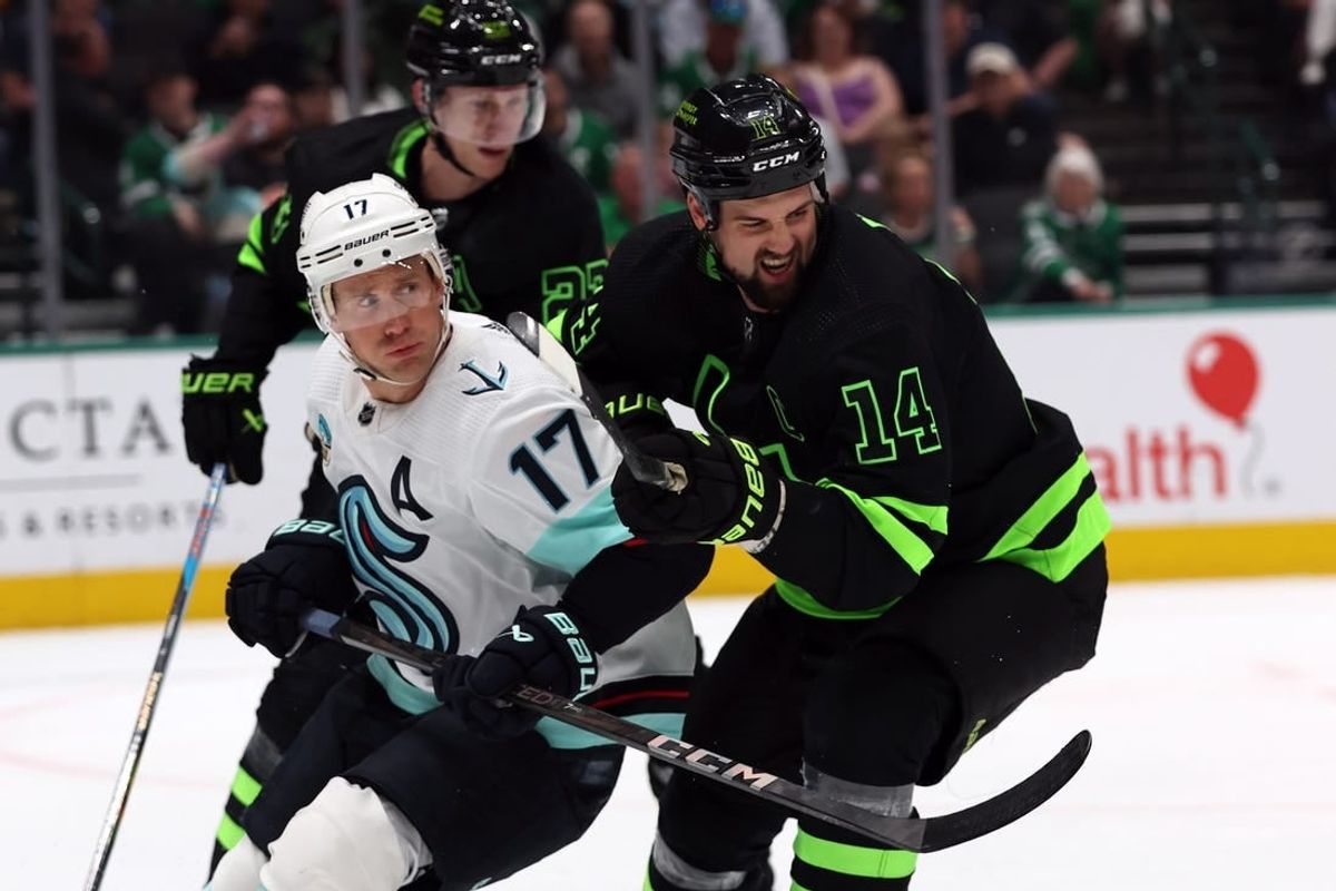 Apr 13, 2024; Dallas, Texas, USA; Dallas Stars left wing Jamie Benn (14) and Seattle Kraken center Jaden Schwartz (17) fight for the puck in the first period at American Airlines Center.