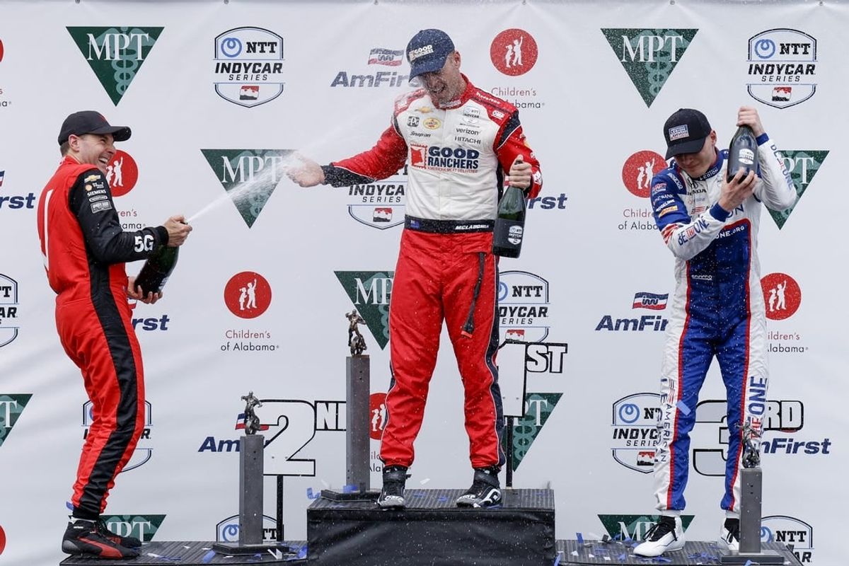 Apr 28, 2024; Birmingham, Alabama, USA;  Team Penske driver Will Power (12) of Australia, Team Penske driver Scott McLaughlin (3) of New Zealand, and Chip Ganassi Racing driver Linus Lundqvist (8) of Sweden celebrate on the podium at Barber Motorsports Park.