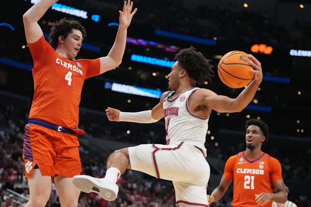 Mar 30, 2024; Los Angeles, CA, USA;  Alabama Crimson Tide guard Mark Sears (1) controls the ball against Clemson Tigers forward Ian Schieffelin (4) in the first half in the finals of the West Regional of the 2024 NCAA Tournament at Crypto.com Arena.