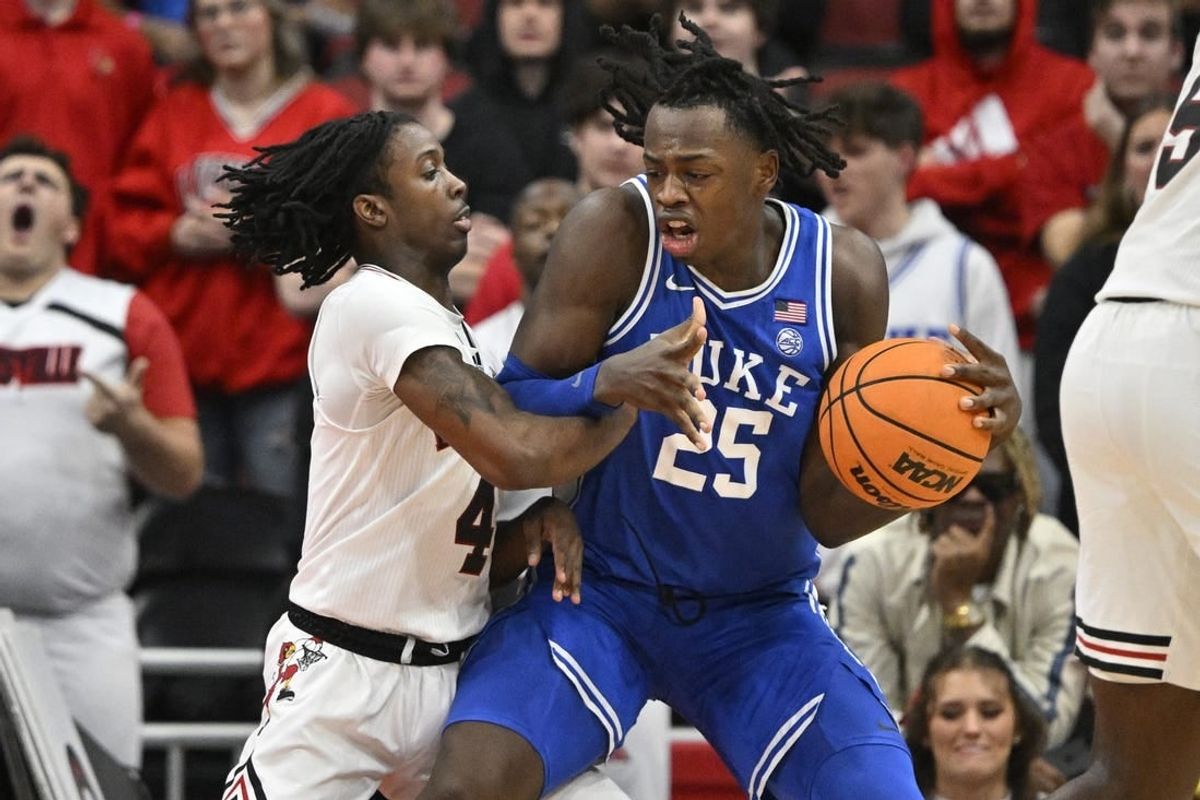 Jan 23, 2024; Louisville, Kentucky, USA;  Duke Blue Devils forward Mark Mitchell (25) posts up against Louisville Cardinals guard Ty-Laur Johnson (4) during the second half at KFC Yum! Center. Duke defeated Louisville 83-69.
