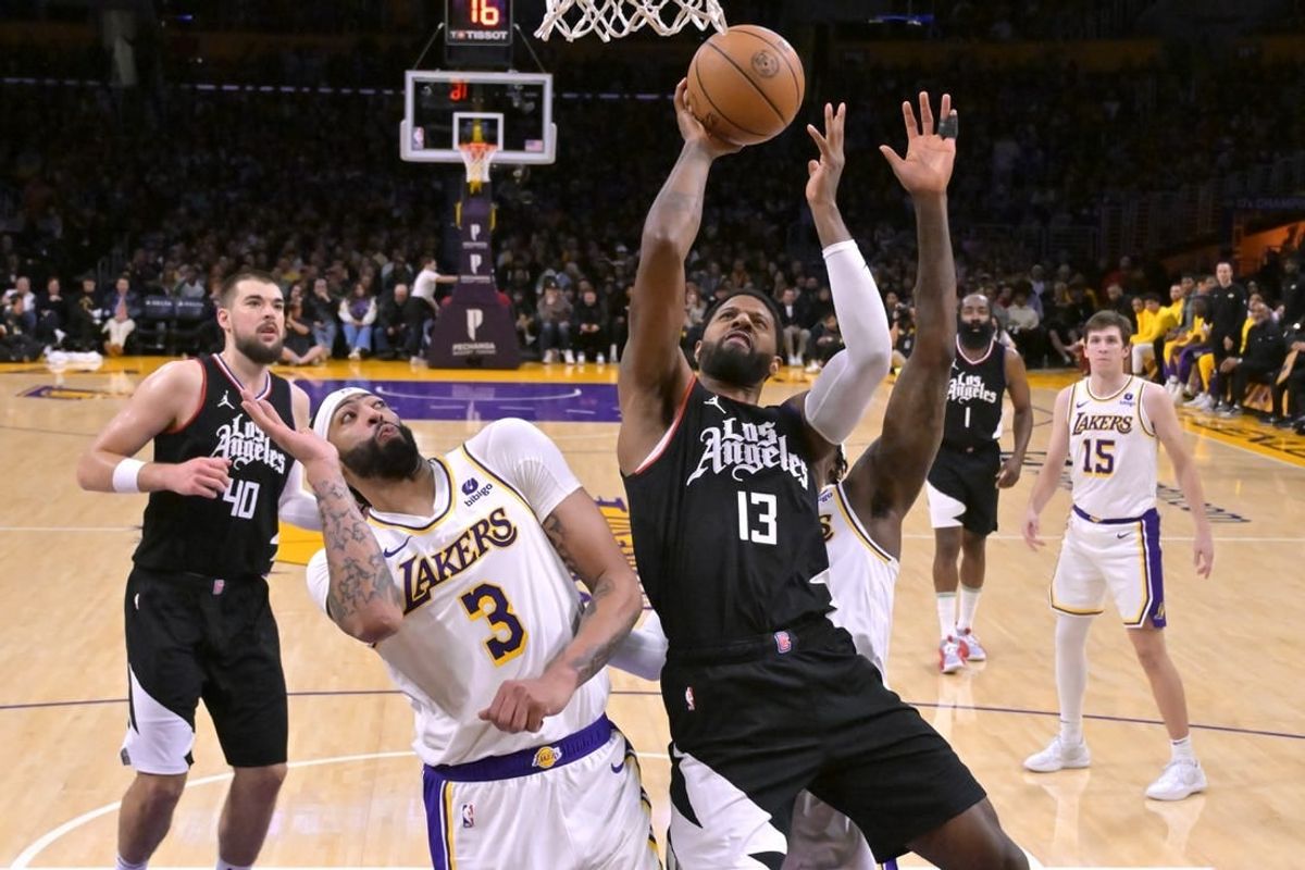 Jan 7, 2024; Los Angeles, California, USA;  Los Angeles Clippers forward Paul George (13) shoots over Los Angeles Lakers forward Anthony Davis (3) in the second half at Crypto.com Arena.