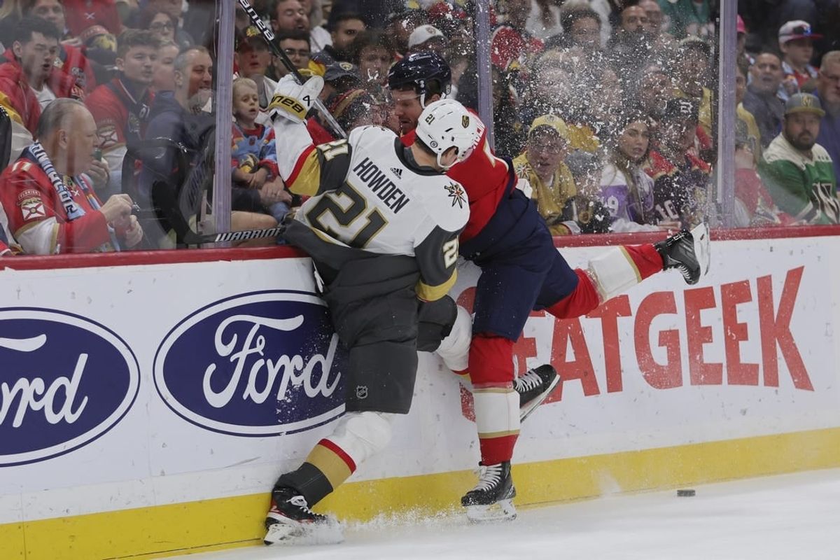 Dec 23, 2023; Sunrise, Florida, USA; Vegas Golden Knights center Brett Howden (21) and Florida Panthers defenseman Dmitry Kulikov (7) battle for the puck during the first period at Amerant Bank Arena.