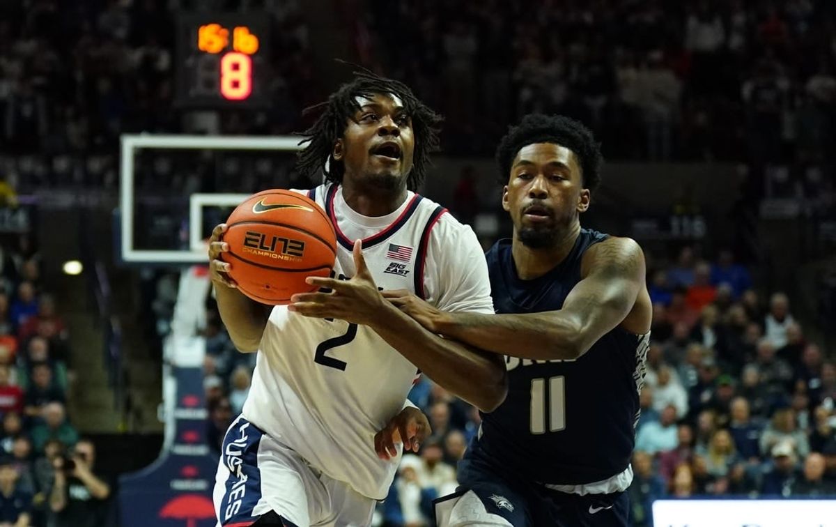 Nov 27, 2023; Storrs, Connecticut, USA; UConn Huskies guard Tristen Newton (2) drives the ball against New Hampshire Wildcats guard Christian Moore (11) in the first half at Harry A. Gampel Pavilion.