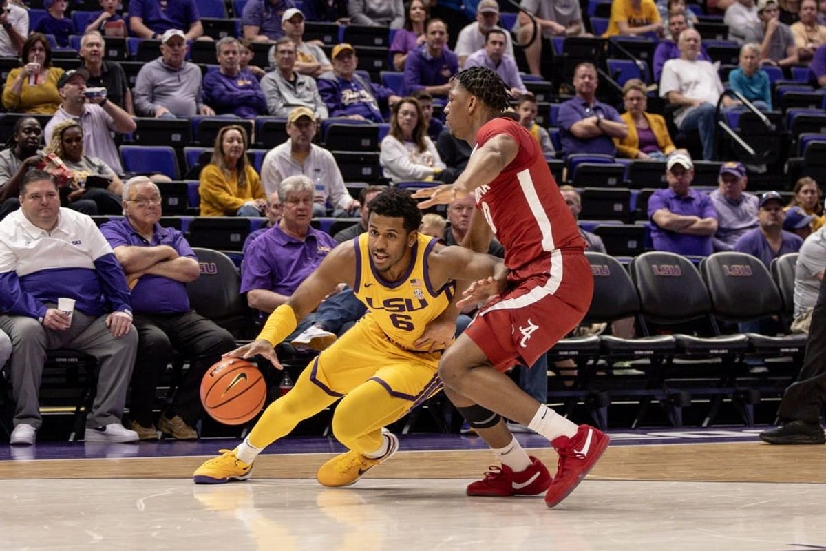 Feb 10, 2024; Baton Rouge, Louisiana, USA;  LSU Tigers guard Jordan Wright (6) dribbles the ball against Alabama Crimson Tide forward Mouhamed Dioubate (10) during the first half at Pete Maravich Assembly Center.