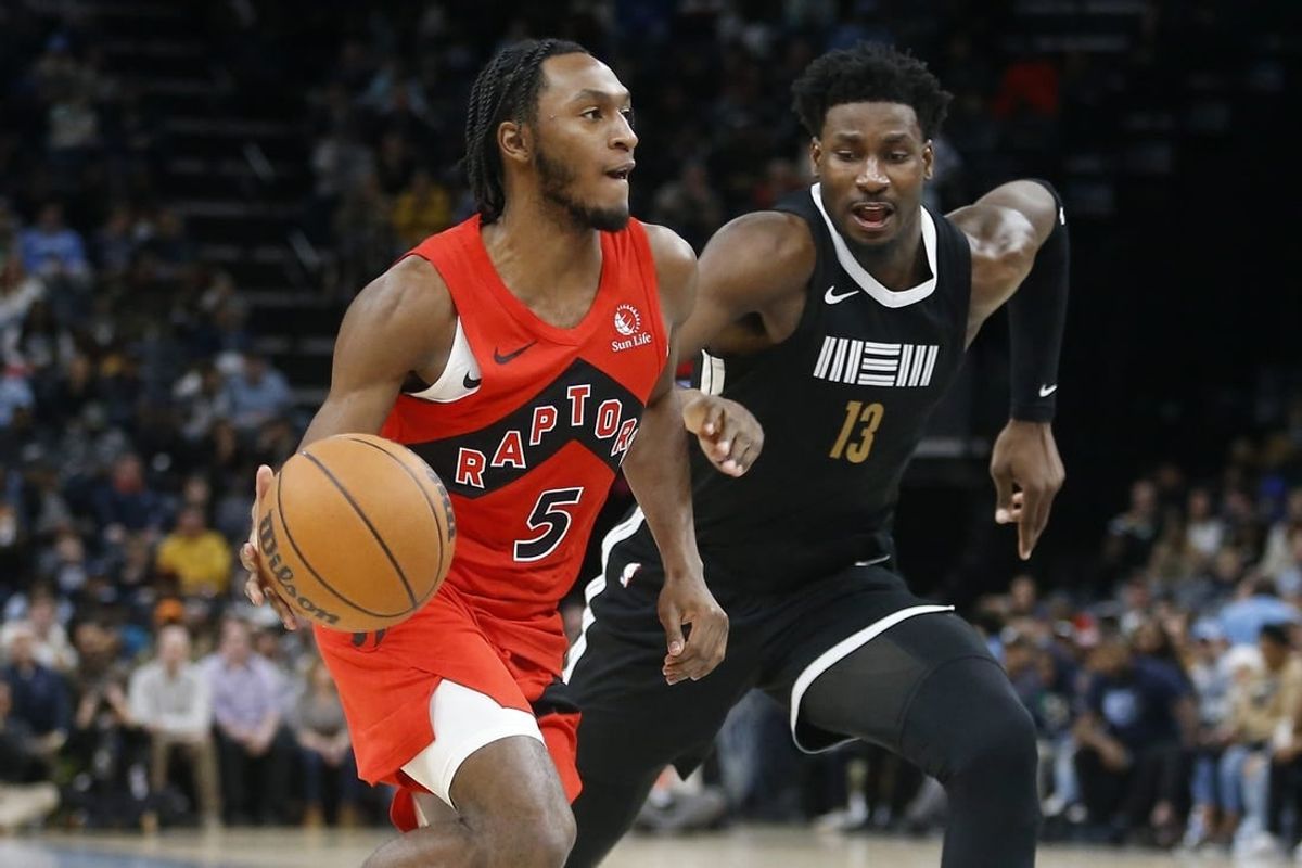Jan 3, 2024; Memphis, Tennessee, USA; Toronto Raptors guard Immanuel Quickley (5) drives to the basket as Memphis Grizzlies forward-center Jaren Jackson Jr. (13) defends during the second half at FedExForum.