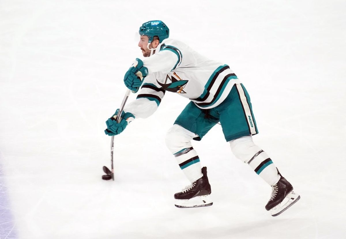 Dec 15, 2023; Tempe, Arizona, USA; San Jose Sharks defenseman Kyle Burroughs (4) passes the puck against the Arizona Coyotes during the third period at Mullett Arena.