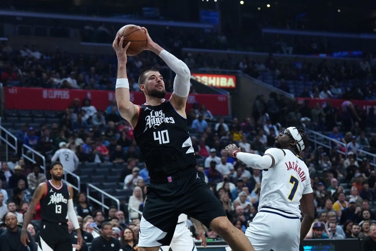 Dec 6, 2023; Los Angeles, California, USA; LA Clippers center Ivica Zubac (40) shoots the ball against Denver Nuggets guard Reggie Jackson (7) in the first half at Crypto.com Arena.