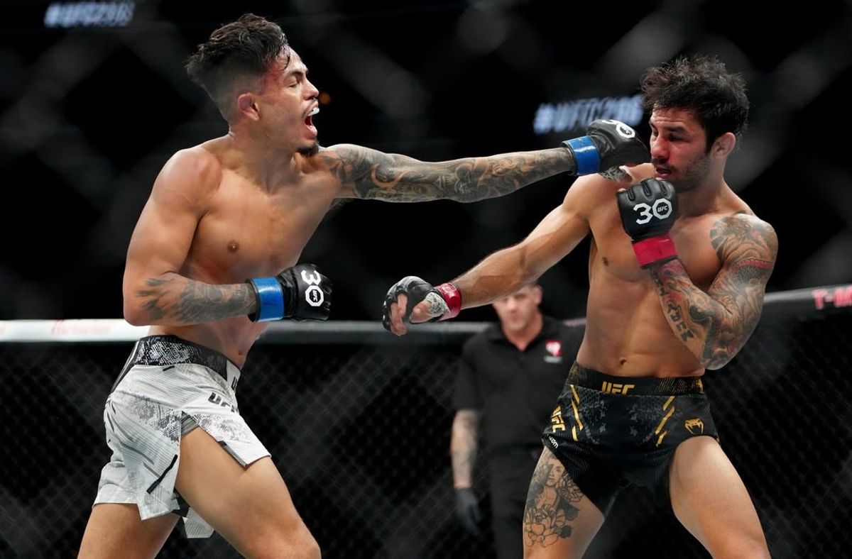 Dec 16, 2023; Las Vegas, Nevada, USA; Alexandre Pantoja (red gloves) fights Brandon Royval (blue gloves) during UFC 296 at T-Mobile Arena.