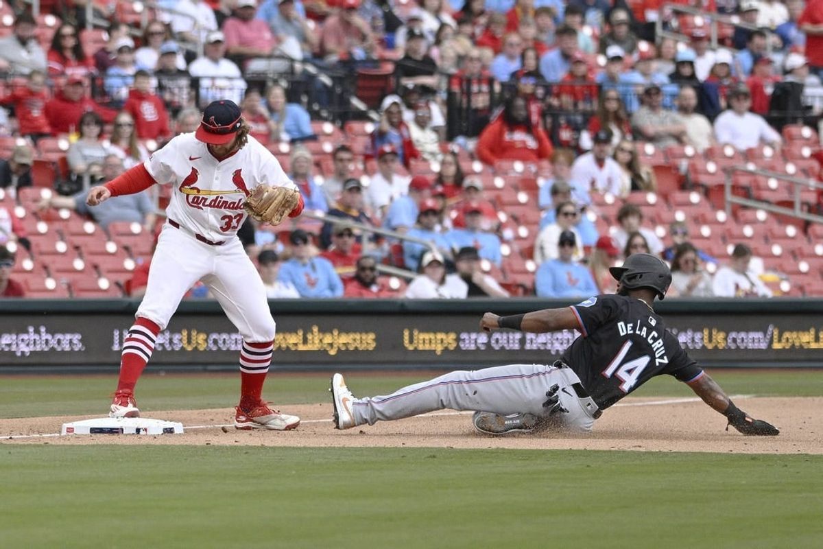 Apr 7, 2024; St. Louis, Missouri, USA; Miami Marlins outfielder Bryan De La Cruz (14) is out at third from St. Louis Cardinals outfielder Brendan Donovan (33) during the eighth inning at Busch Stadium.