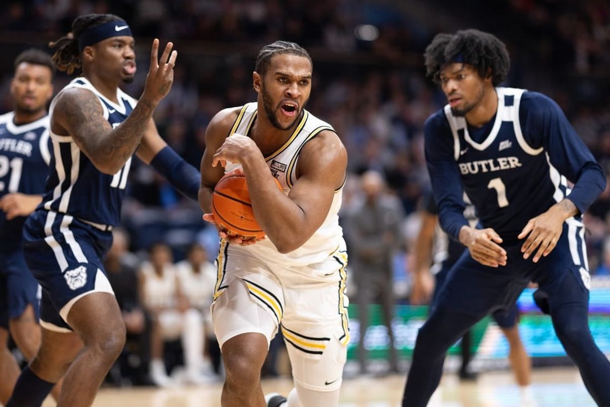 Feb 20, 2024; Villanova, Pennsylvania, USA; Villanova Wildcats forward Eric Dixon (43) controls the ball against Butler Bulldogs guard Jahmyl Telfort (11) and forward Jalen Thomas (1) during the second half at William B. Finneran Pavilion.