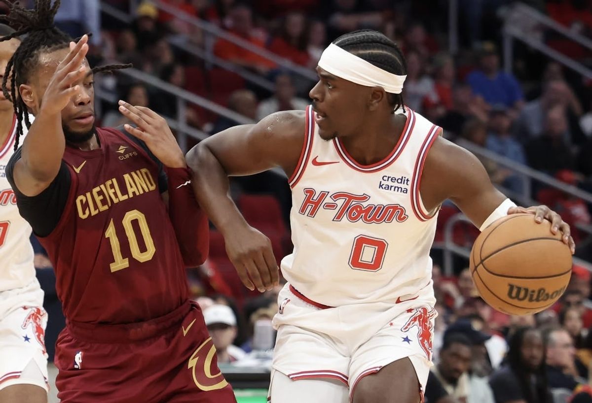 Mar 16, 2024; Houston, Texas, USA;  Houston Rockets guard Aaron Holiday (0) dribbles against Cleveland Cavaliers guard Darius Garland (10) in the second quarter at Toyota Center.