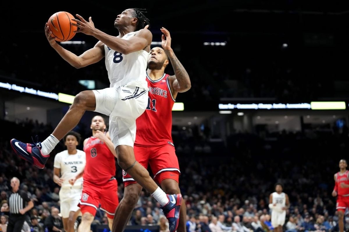 Xavier Musketeers guard Quincy Olivari (8) scores at the basket in the first half of a college basketball game between the St. John's Red Storm and the Xavier Musketeers, Wednesday, Jan. 31, 2024, at Cintas Center in Cincinnati.