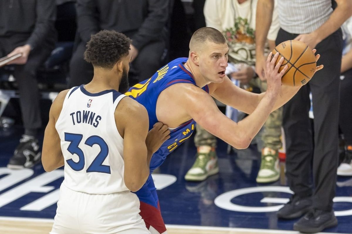 May 10, 2024; Minneapolis, Minnesota, USA; Denver Nuggets center Nikola Jokic (15) looks to pass the ball around Minnesota Timberwolves center Karl-Anthony Towns (32) in the first half during game three of the second round for the 2024 NBA playoffs at Target Center.