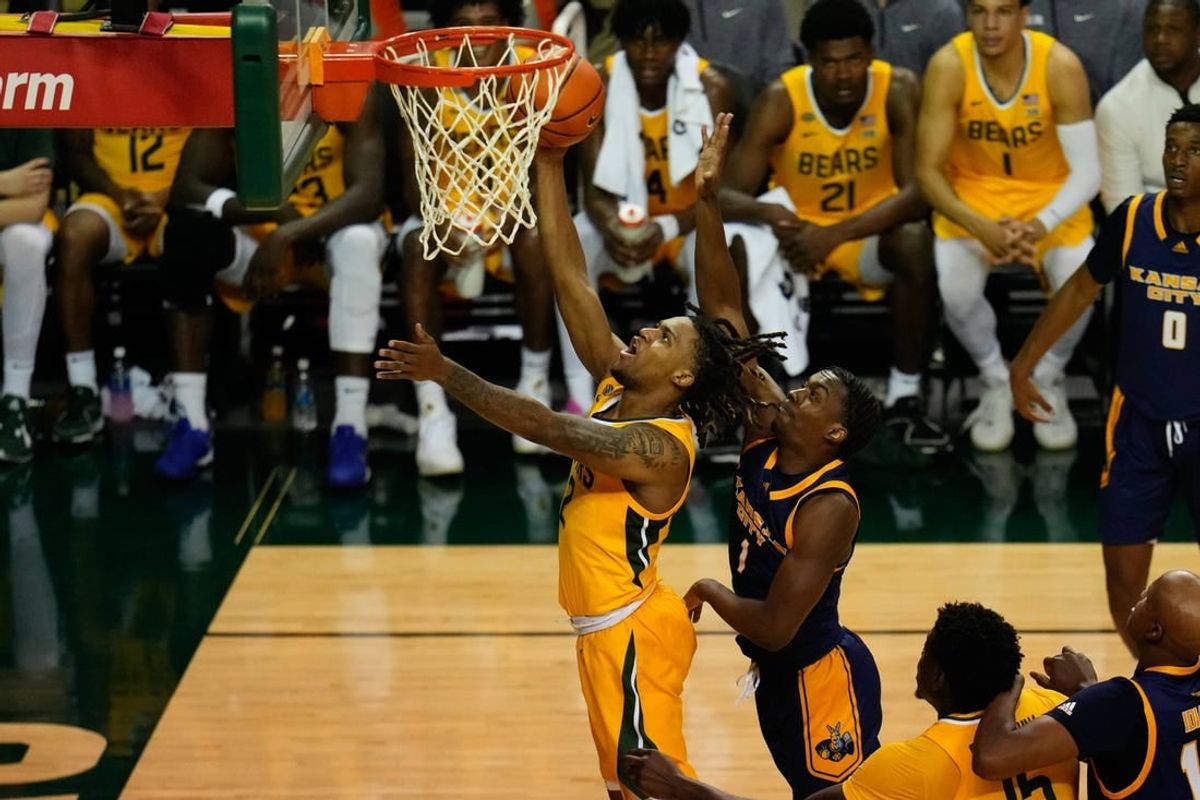 Nov 14, 2023; Waco, Texas, USA; Baylor Bears guard Jayden Nunn (2) scores a layup past UMKC Kangaroos guard Jayson Petty (1) during the second half at Ferrell Center.