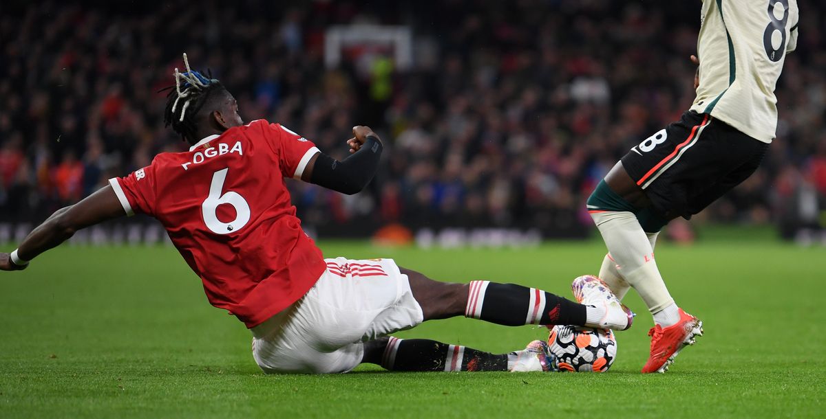 Naby Keita of Liverpool is fouled by Paul Pogba of Manchester United leading to a red card being shown following a VAR review during the Premier League match between Manchester United and Liverpool at Old Trafford.