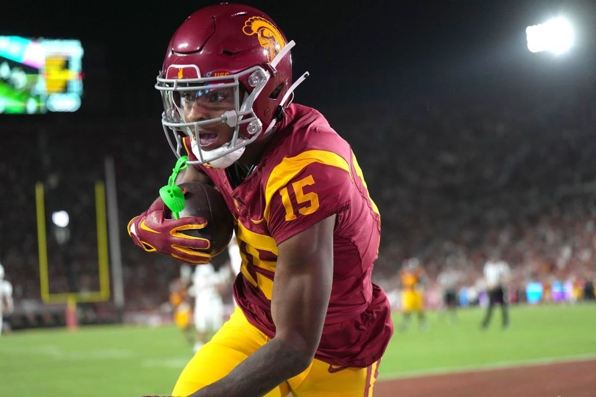 Sep 9, 2023; Los Angeles, California, USA; Southern California Trojans wide receiver Dorian Singer (15) catches a 19-yard touchdown pass against the Stanford Cardinal in the first half at United Airlines Field at Los Angeles Memorial Coliseum.