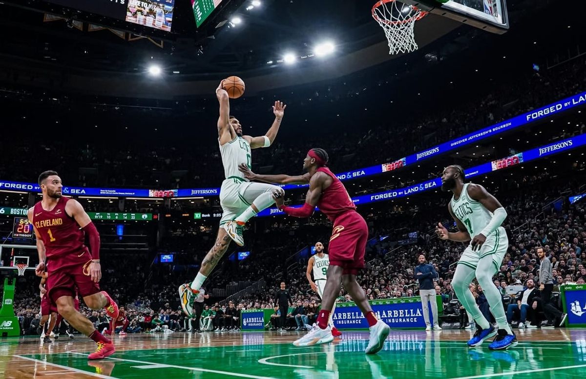 Dec 14, 2023; Boston, Massachusetts, USA; Boston Celtics forward Jayson Tatum (0) drives to the basket against Cleveland Cavaliers guard Caris LeVert (3) in the second half at TD Garden.