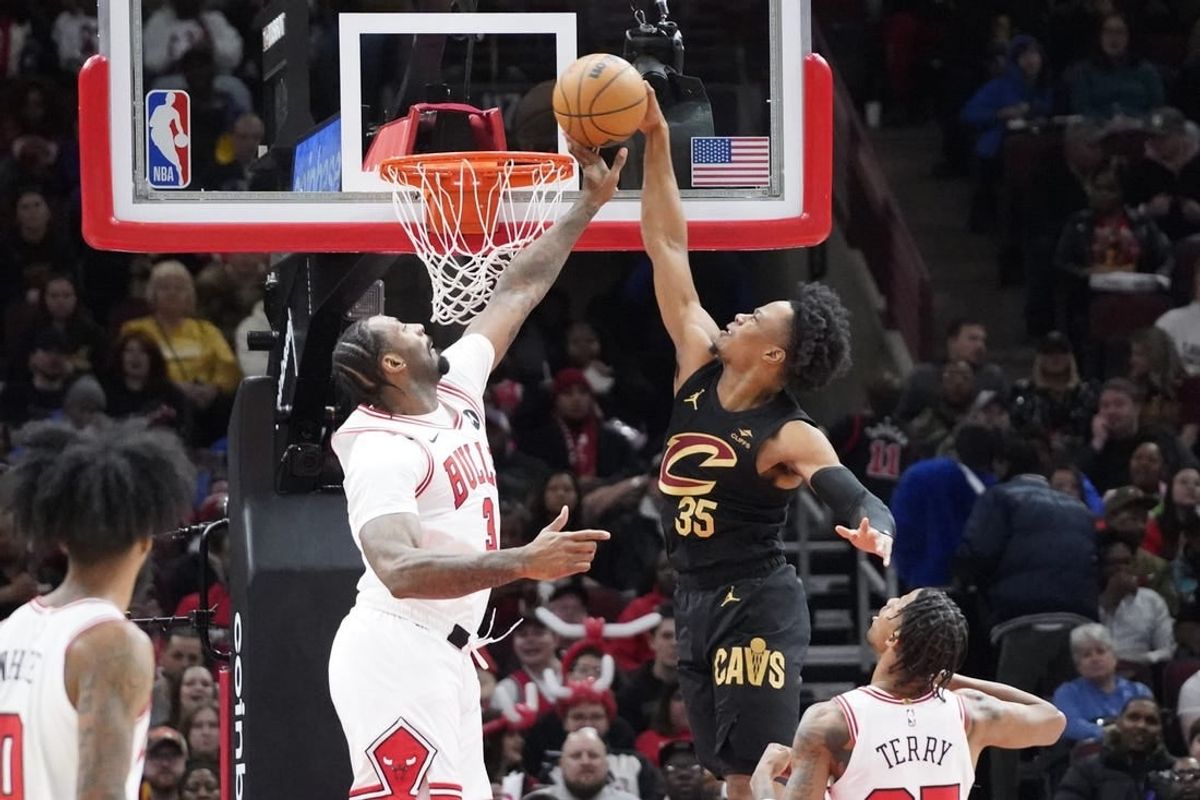 Feb 28, 2024; Chicago, Illinois, USA; Chicago Bulls center Andre Drummond (3) defends Cleveland Cavaliers forward Isaac Okoro (35) during the first quarter at United Center.