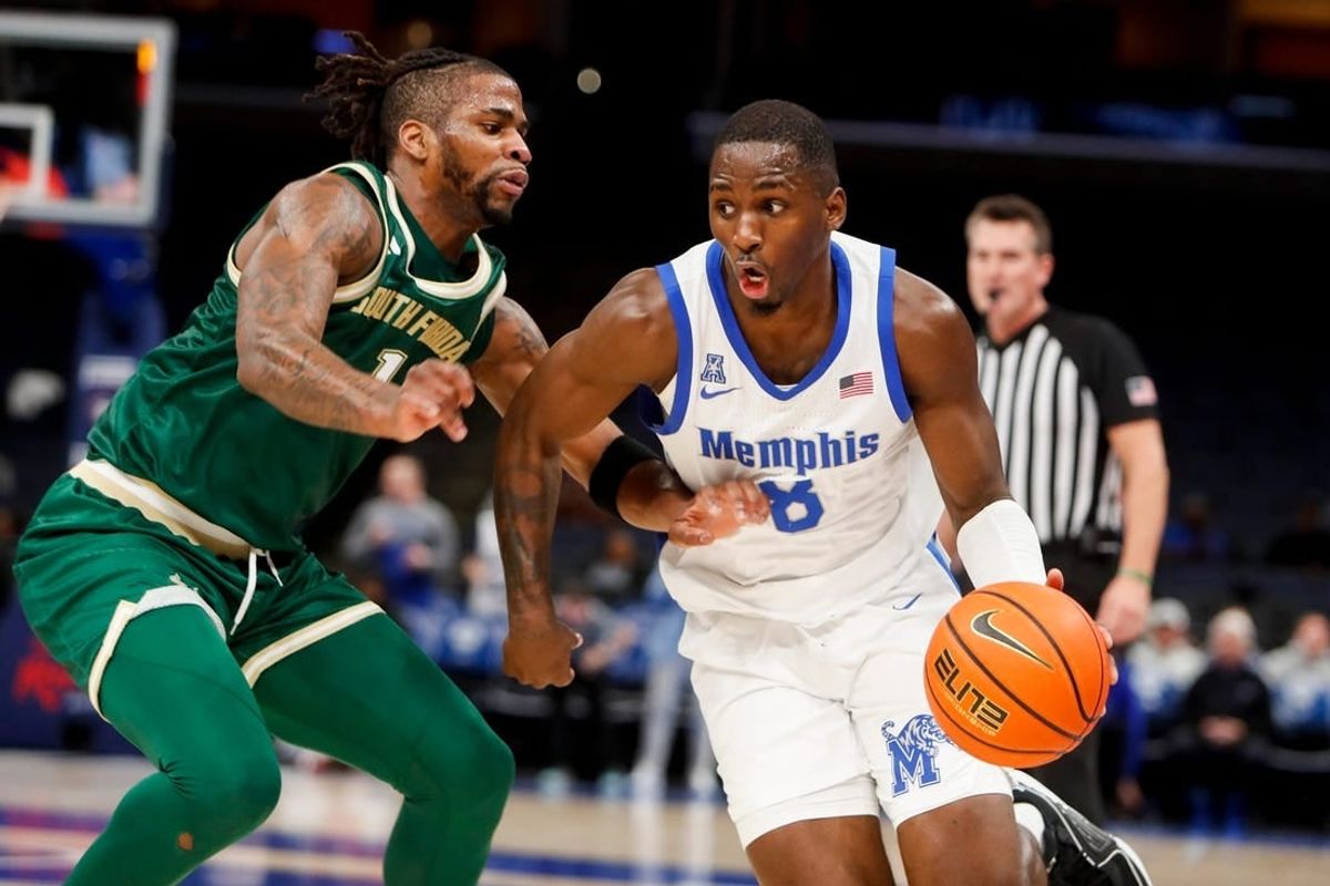 Jan 18, 2024; Memphis, Tennessee, USA; Memphis Tigers forward David Jones (8) drives to the basket against South Florida Bulls guard Selton Miguel (1) during the game between the University of South Florida and the University of Memphis at FedExForum.
