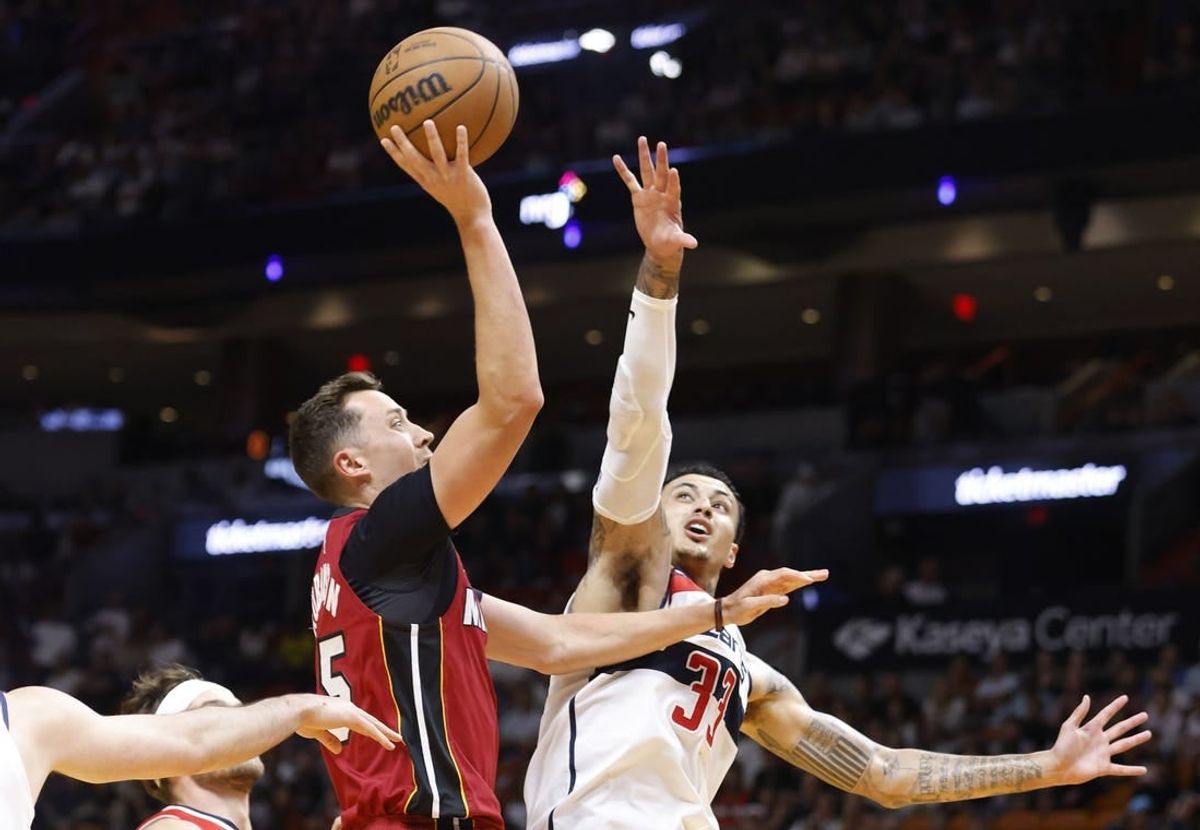 Mar 10, 2024; Miami, Florida, USA; Miami Heat forward Duncan Robinson (55) shoots over Washington Wizards forward Kyle Kuzma (33) in the first half at Kaseya Center.