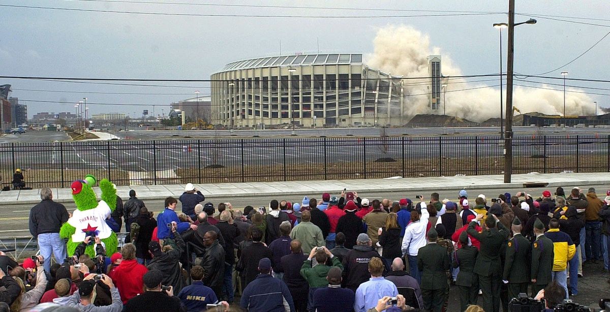 The Phanatic (l., green) looks on in horror as Veterans Stadium implodes in 2004.
