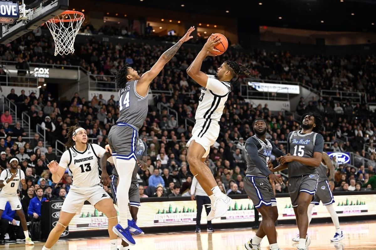 Jan 3, 2024; Providence, Rhode Island, USA; Providence Friars forward Bryce Hopkins (23) shoots the ball over Seton Hall Pirates guard Dre Davis (14) during the first half at Amica Mutual Pavilion.