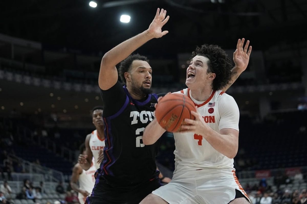 Dec 9, 2023; Toronto, Ontario, CAN; Clemson Tigers forward Ian Schieffelin (4) goes to shoot as TCU Horned Frogs forward JaKobe Coles (21) defends during the second half at Coca-Cola Coliseum.