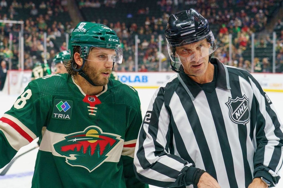 Sep 28, 2023; Saint Paul, Minnesota, USA; Minnesota Wild right wing Ryan Hartman (38) and referee Chris Lee (82) chat during a break in action against the Colorado Avalanche in the third period at Xcel Energy Center.