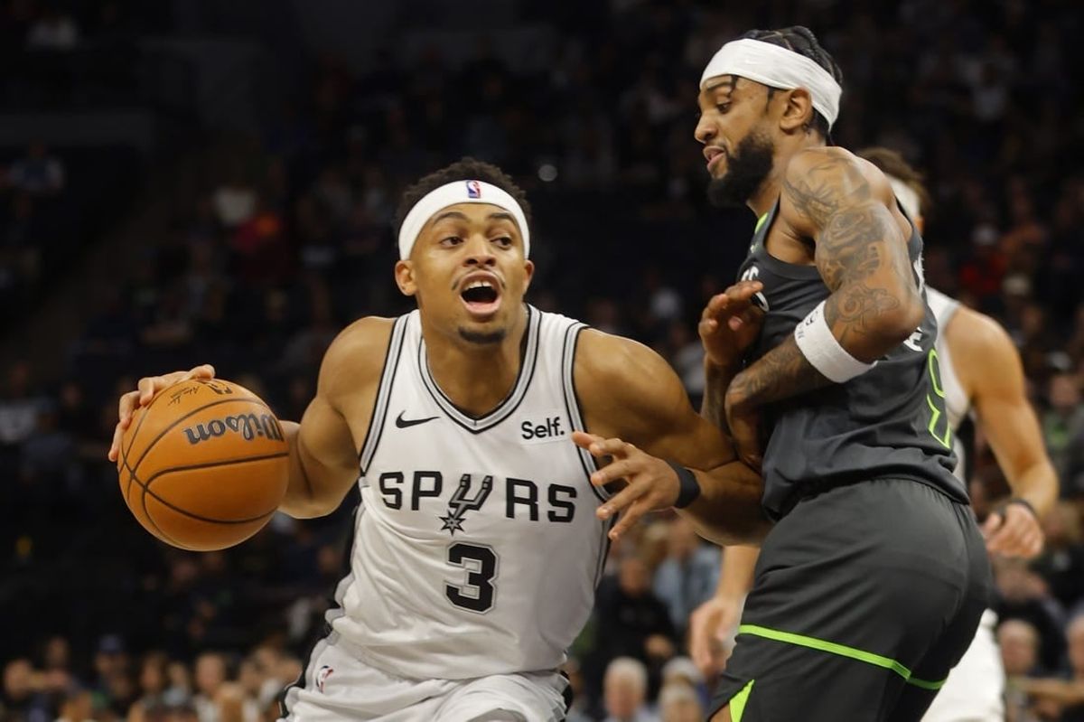 Dec 6, 2023; Minneapolis, Minnesota, USA; San Antonio Spurs forward Keldon Johnson (3) works against Minnesota Timberwolves guard Nickeil Alexander-Walker (9) in the first quarter at Target Center.