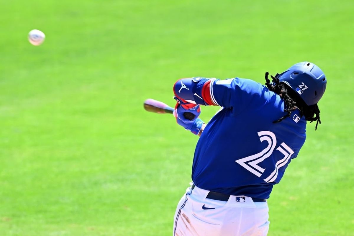 Mar 15, 2024; Dunedin, Florida, USA; Toronto Blue Jays first baseman Vladimir Guerrero Jr. (27) hits a line drive in the third inning of a spring training game against the Detroit Tigers at TD Ballpark.