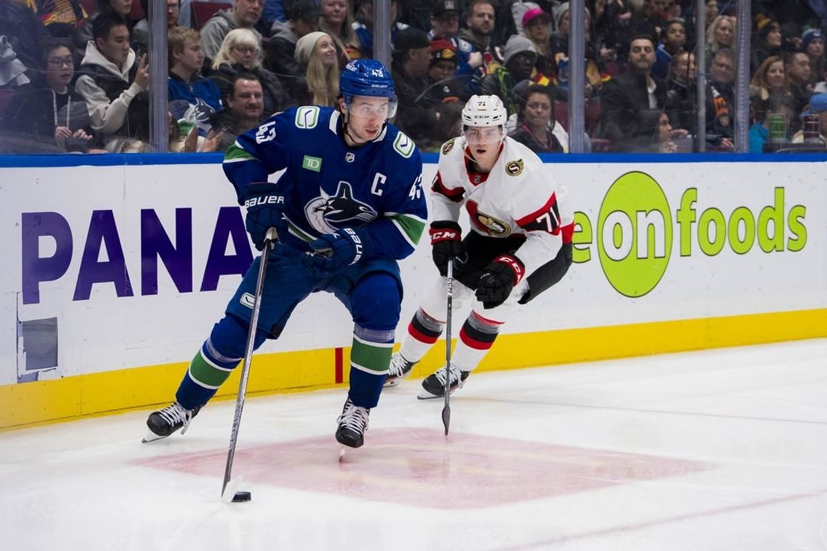 Jan 2, 2024; Vancouver, British Columbia, CAN; Ottawa Senators forward Ridly Greig (71) pursues Vancouver Canucks defenseman Quinn Hughes (43) in the second period at Rogers Arena.