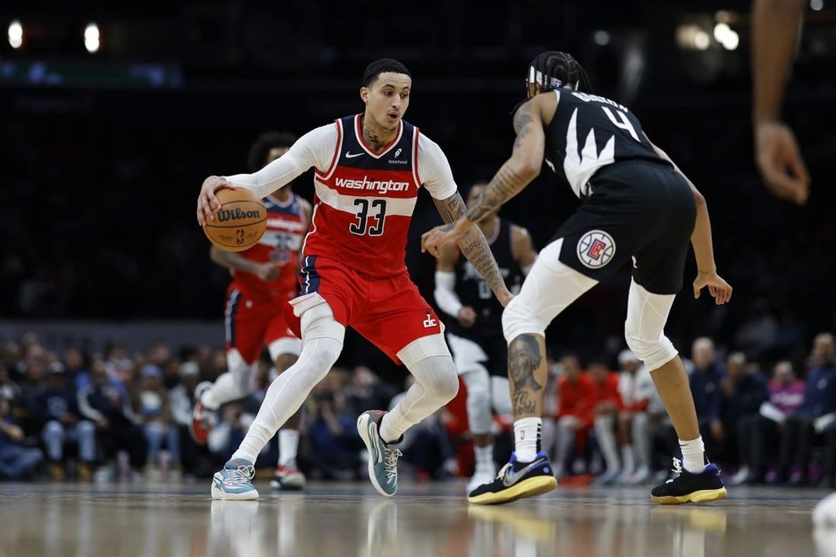 Jan 31, 2024; Washington, District of Columbia, USA; Washington Wizards forward Kyle Kuzma (33) drives to the basket as LA Clippers guard Brandon Boston Jr. (4) defends in the first half at Capital One Arena.