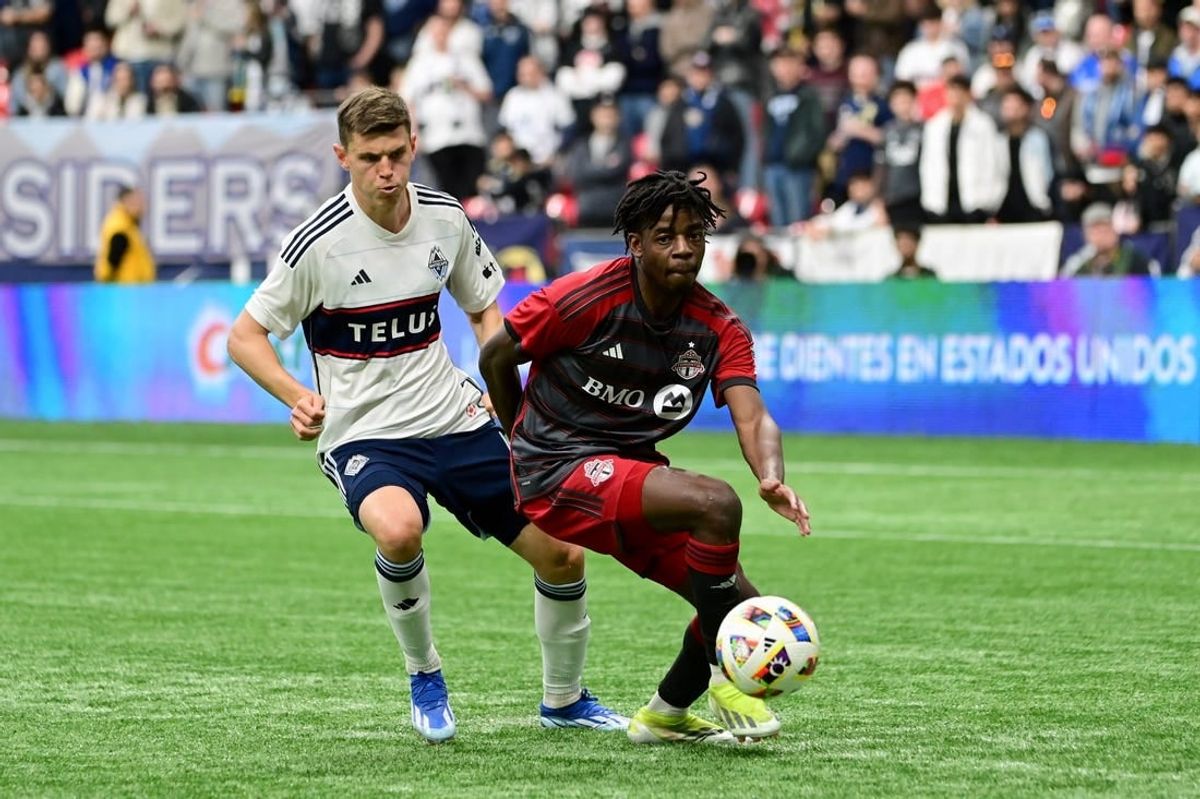 Apr 6, 2024; Vancouver, British Columbia, CAN; Toronto FC forward Deandre Kerr (29) controls the ball against Vancouver Whitecaps FC defender Ranko Veselinovic (4) in the first half at BC Place.