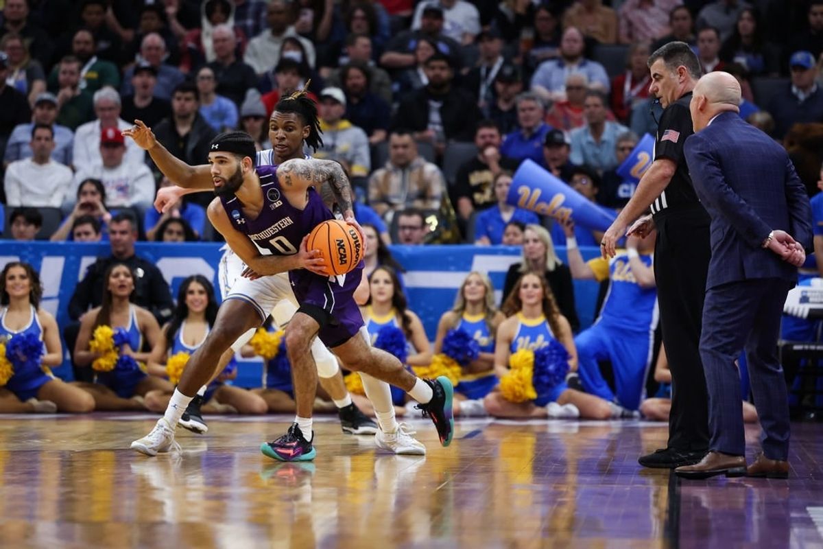 Mar 18, 2023; Sacramento, CA, USA; Northwestern Wildcats guard Boo Buie (0) looks for a pass while defended by UCLA Bruins guard Dylan Andrews (2) during the first half at Golden 1 Center.
