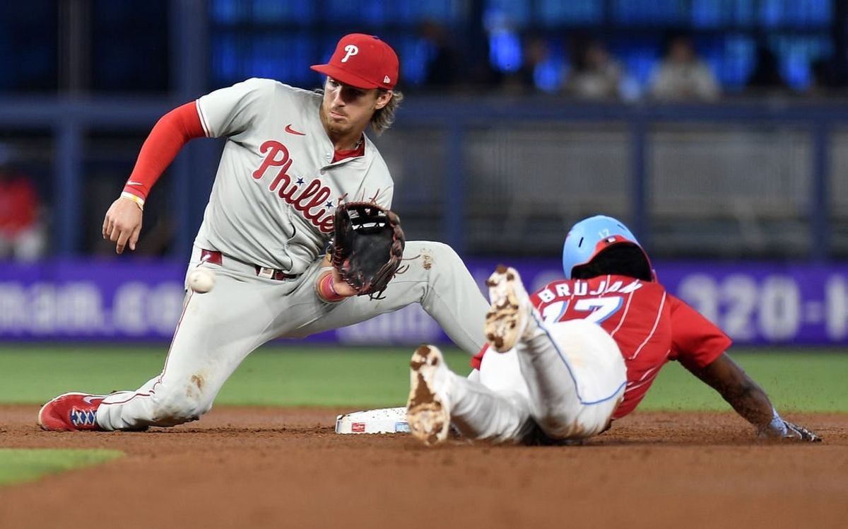 May 11, 2024; Miami, Florida, USA;  Philadelphia Phillies second baseman Bryson Stott (5) tags out Miami Marlins shortstop Vidal Bruján (17) during the second inning at loanDepot Park.