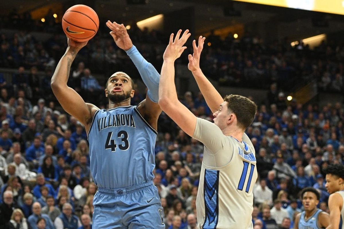 Dec 20, 2023; Omaha, Nebraska, USA;  Villanova Wildcats forward Eric Dixon (43) scores against Creighton Bluejays center Ryan Kalkbrenner (11) in the first half at CHI Health Center Omaha.