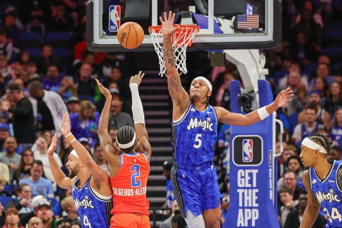 Feb 13, 2024; Orlando, Florida, USA; Oklahoma City Thunder guard Shai Gilgeous-Alexander (2) shoots the ball over Orlando Magic forward Paolo Banchero (5) during the first quarter at Amway Center.