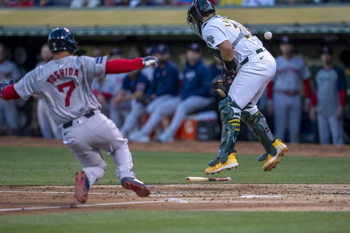 Apr 1, 2024; Oakland, California, USA; Boston Red Sox left fielder Masataka Yoshida (7) scores on the throw to Oakland Athletics catcher Shea Langeliers (23) during the second inning at Oakland-Alameda County Coliseum.