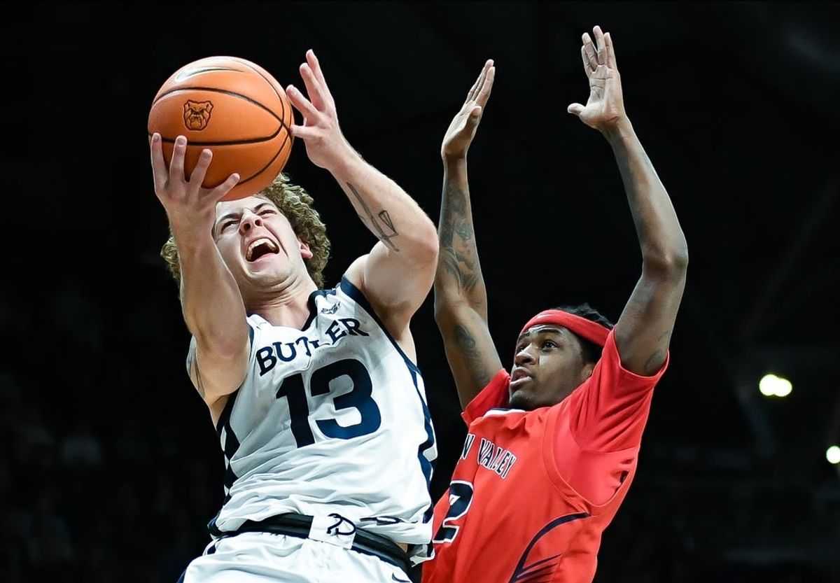Dec 15, 2023; Indianapolis, Indiana, USA; Butler Bulldogs guard Finley Bizjack (13) goes to the basket against Saginaw Valley State Cardinals guard Curtis Jackson (2) during the first half at Hinkle Fieldhouse.