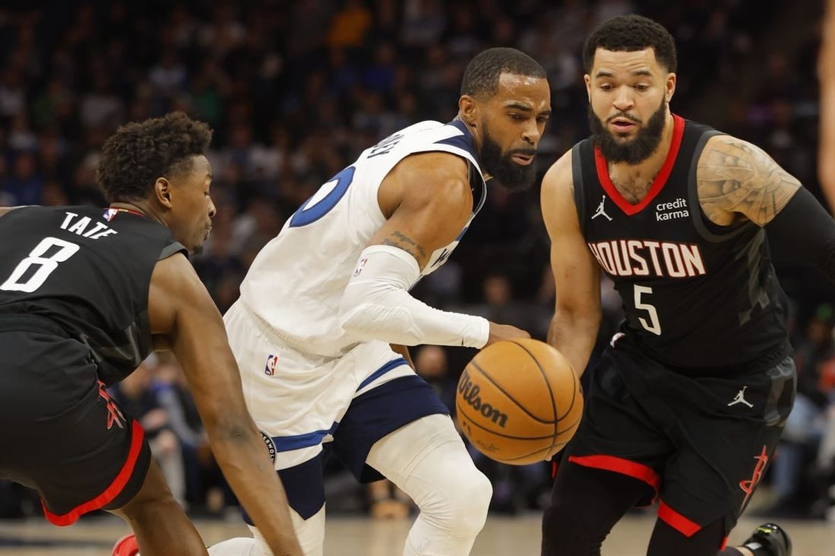 Feb 4, 2024; Minneapolis, Minnesota, USA; Minnesota Timberwolves guard Mike Conley (10) drives between Houston Rockets forward Jae'Sean Tate (8) and guard Fred VanVleet (5) in the first quarter at Target Center.