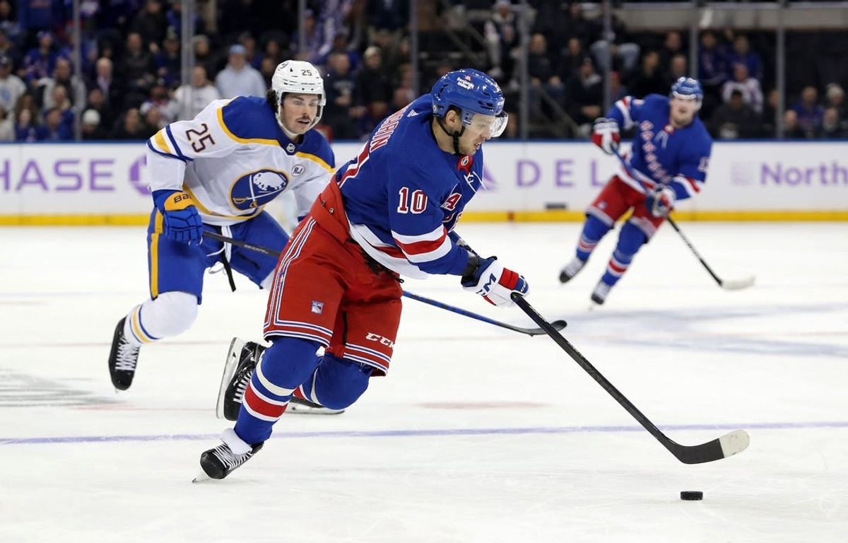 Nov 27, 2023; New York, New York, USA; New York Rangers left wing Artemi Panarin (10) skates with the puck in front of Buffalo Sabres defenseman Owen Power (25) during the second period at Madison Square Garden.