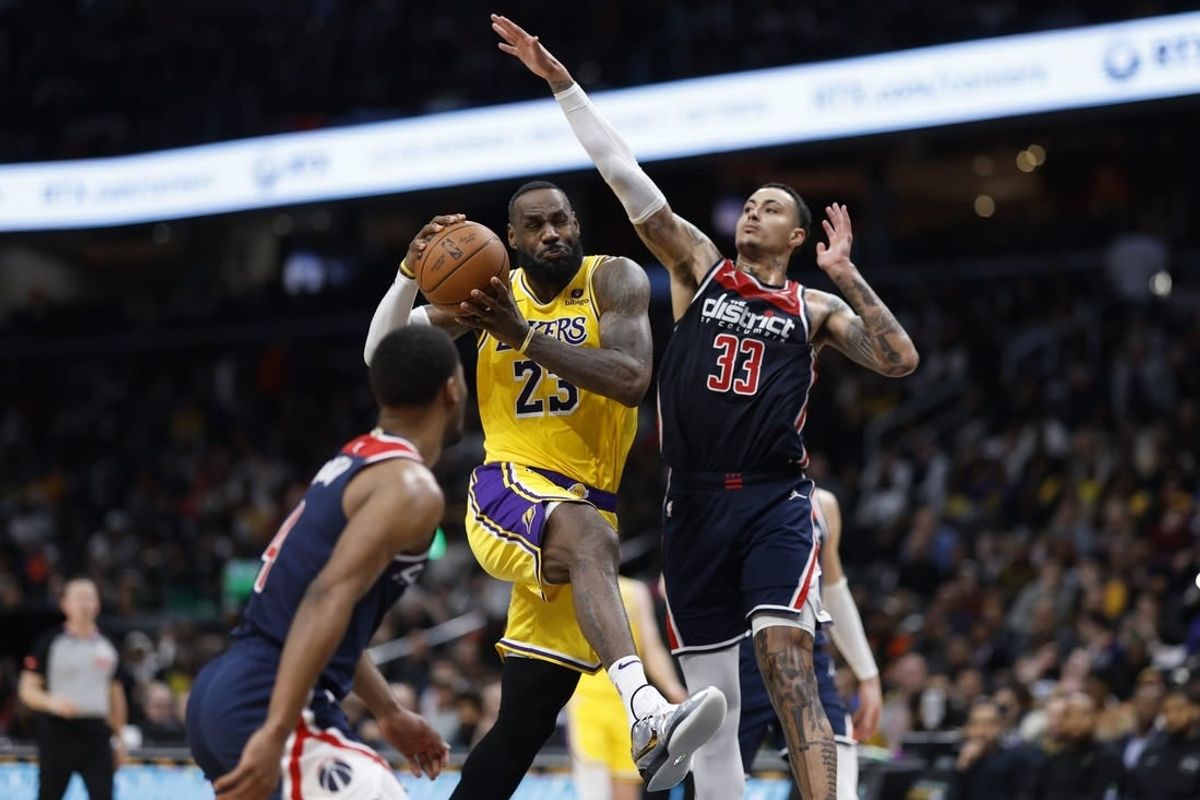 Apr 3, 2024; Washington, District of Columbia, USA; Los Angeles Lakers forward LeBron James (23) drives to the basket as Washington Wizards forward Kyle Kuzma (33) defends in the first half at Capital One Arena.