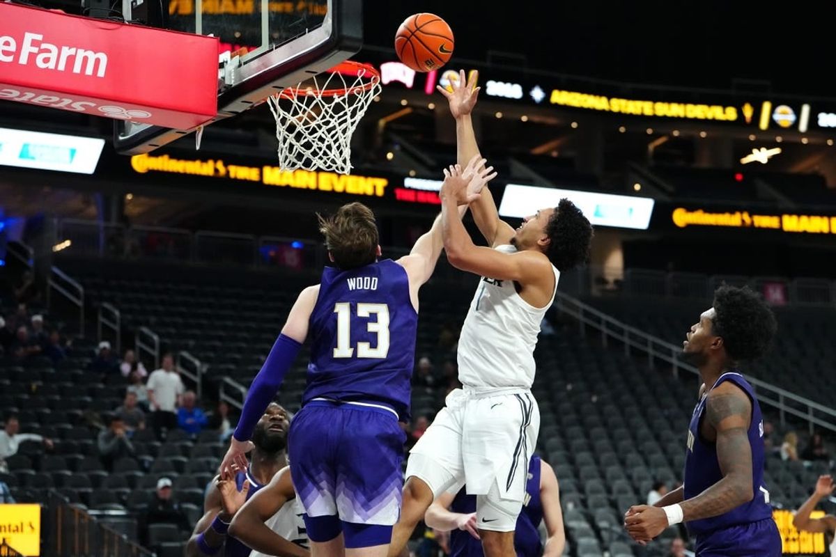 Nov 17, 2023; Las Vegas, Nevada, USA; Xavier Musketeers guard Desmond Claude (1) shoots against Washington Huskies forward Moses Wood (13) during the second half at T-Mobile Arena.