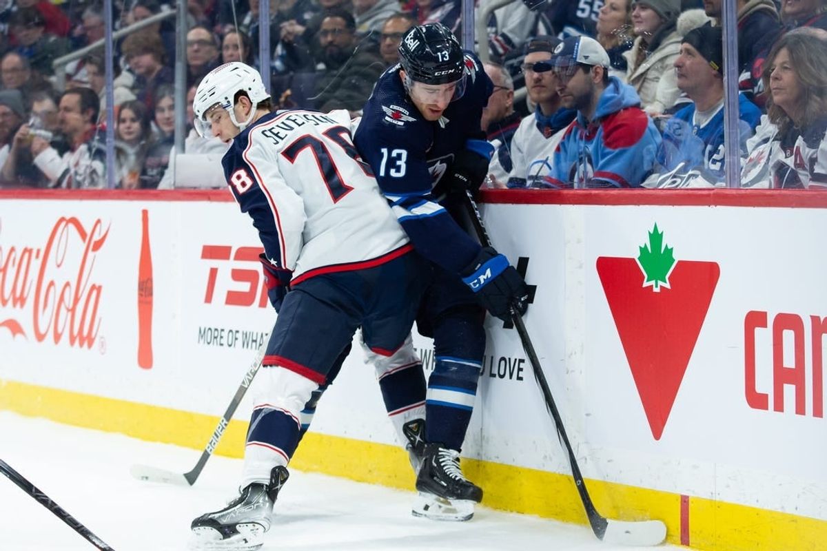 Jan 9, 2024; Winnipeg, Manitoba, CAN; Columbus Blue Jackets defenseman Damon Severson (78) boards Winnipeg Jets forward Gabriel Vilardi (13) during the second period at Canada Life Centre.